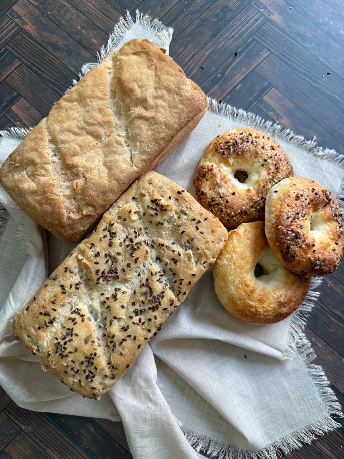 Loaves and everything bagels on linen, from above