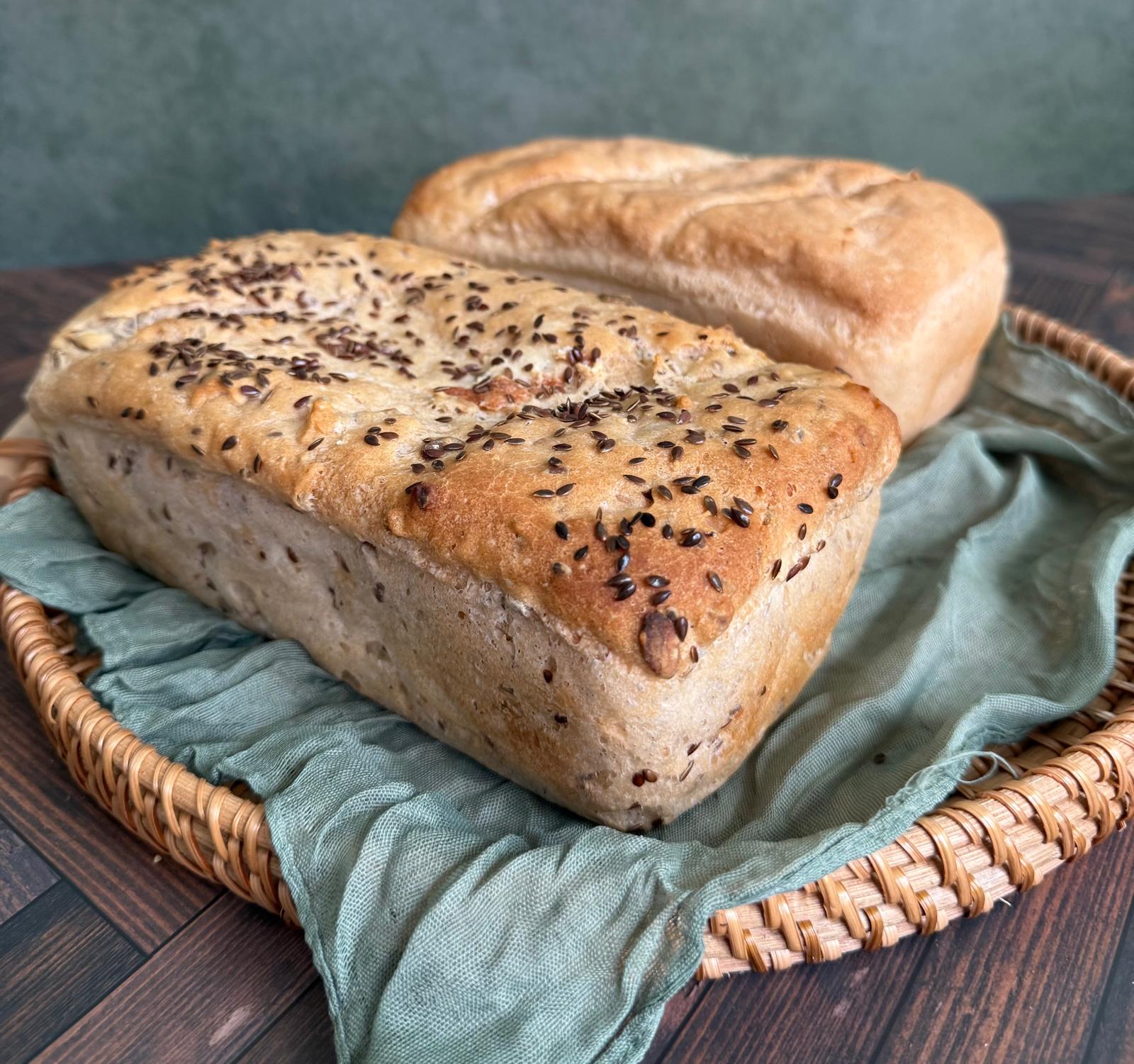 Seeded and classic loaves in a woven basket
