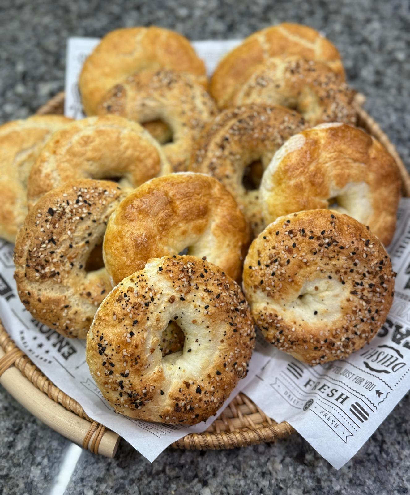 Fresh plain and everything gluten-free bagels in a basket
