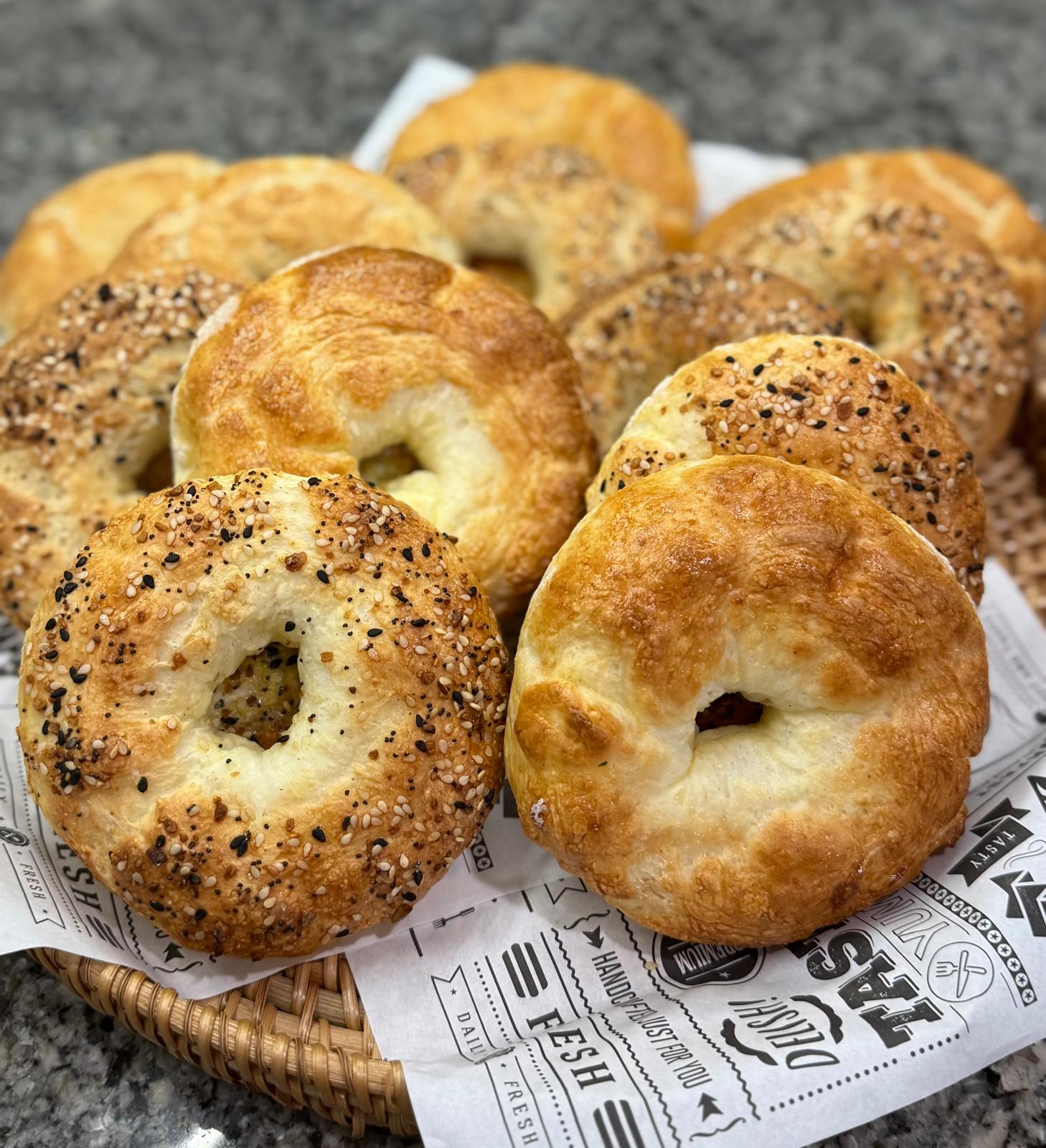 Fresh plain and everything bagels in a basket