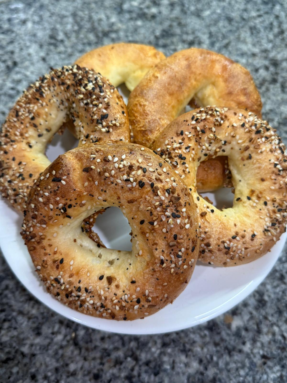 Everything and plain gluten-free bagels on a plate
