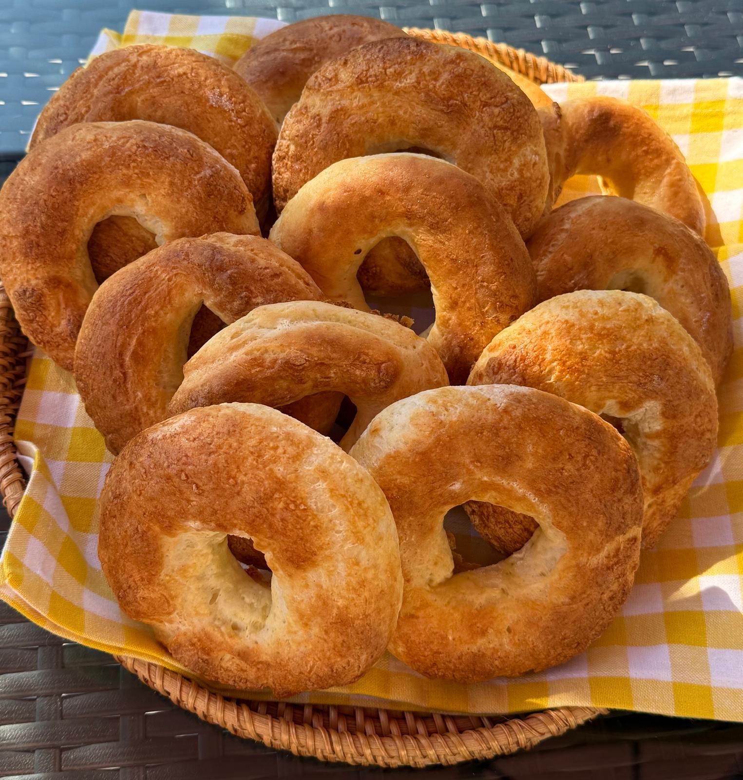 Fresh gluten-free bagels in a yellow basket