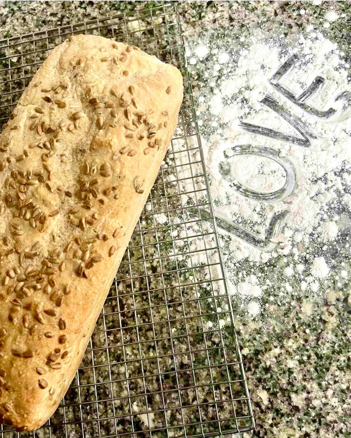 Gluten-free loaf beside love written in flour