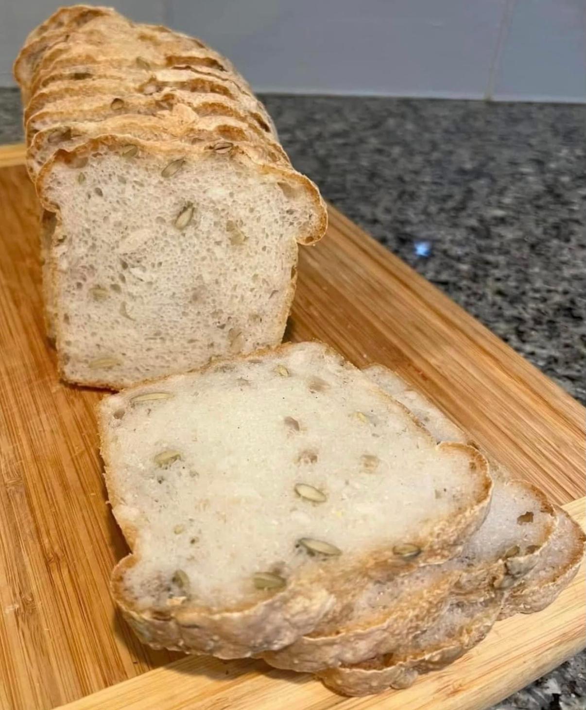 Seeded loaf with slices arranged on a board