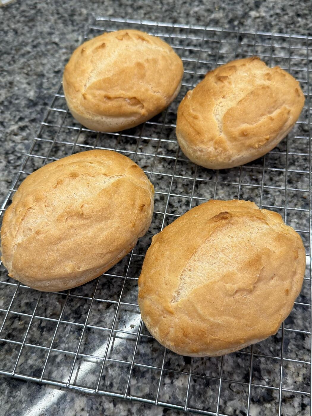 Plain gluten-free rolls on a rack