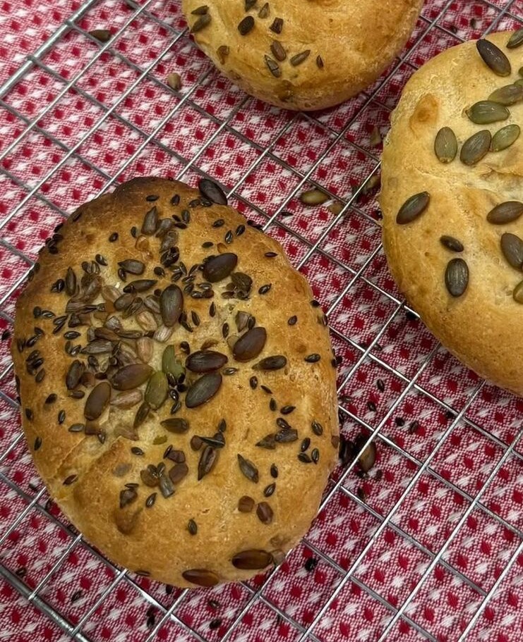 Close view of freshly baked seeded gluten-free rolls